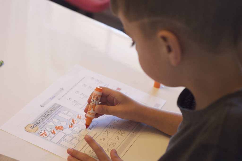 boy working on math page close up